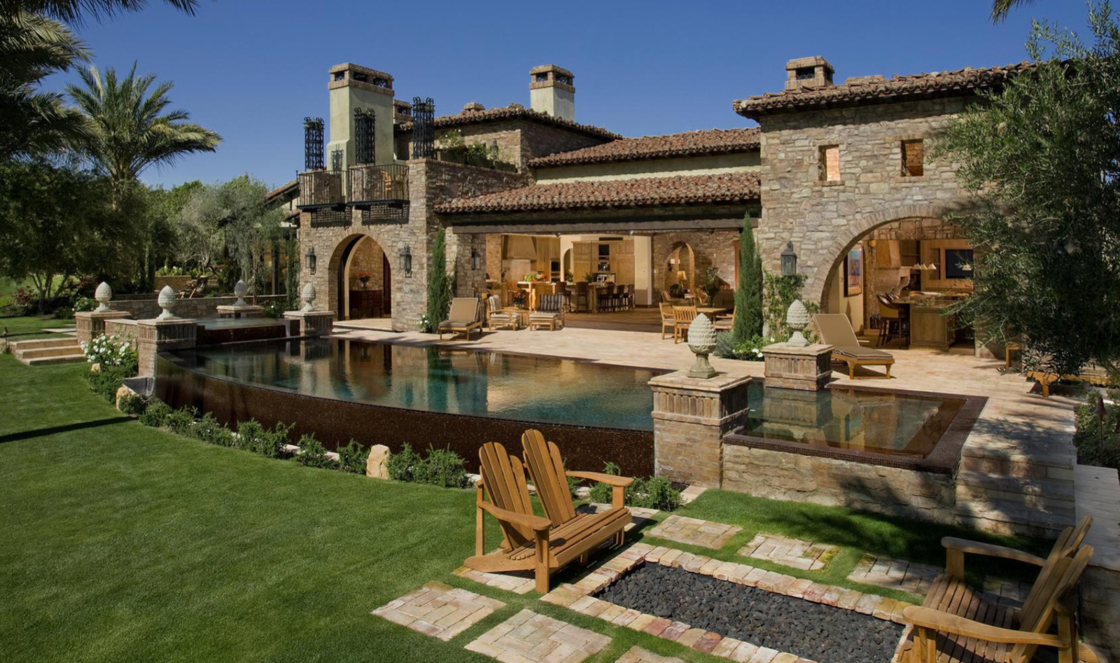 Tuscan-inspired hand-laid stone estate with barrel-vault entry and travertine courtyard, San Diego California