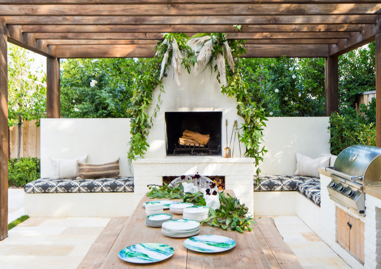 Pergola outdoor kitchen with fireplace and dining