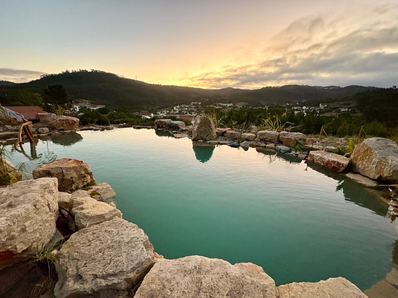 Chemical-free natural swimming pond with stone boulders and waterfalls, Lisbon Portugal